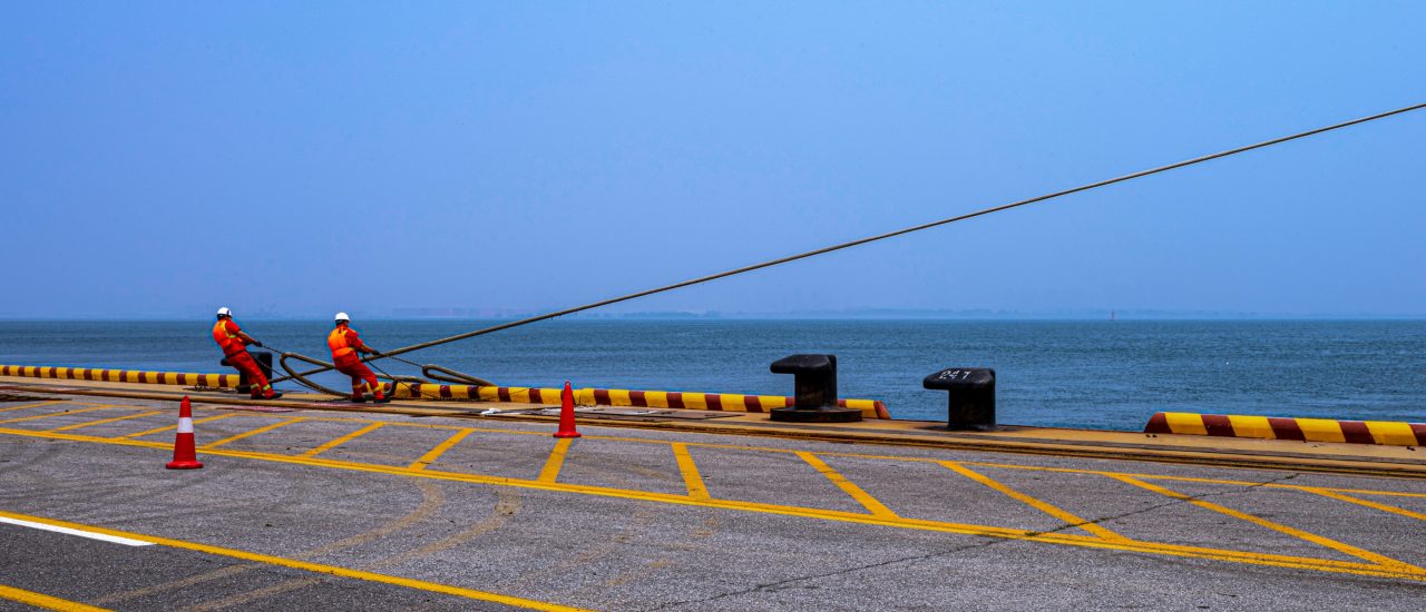 Dock Workers Pulling Mooring Rope